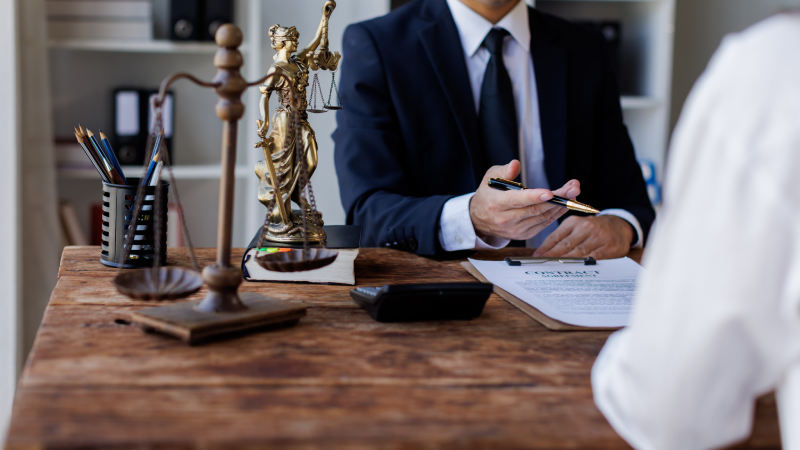Two lawyers Consultation and conference discussing legal matters at a desk with a gavel, scales of justice law symbolizing law and justice, justice and lawyer Business partnership meeting concept